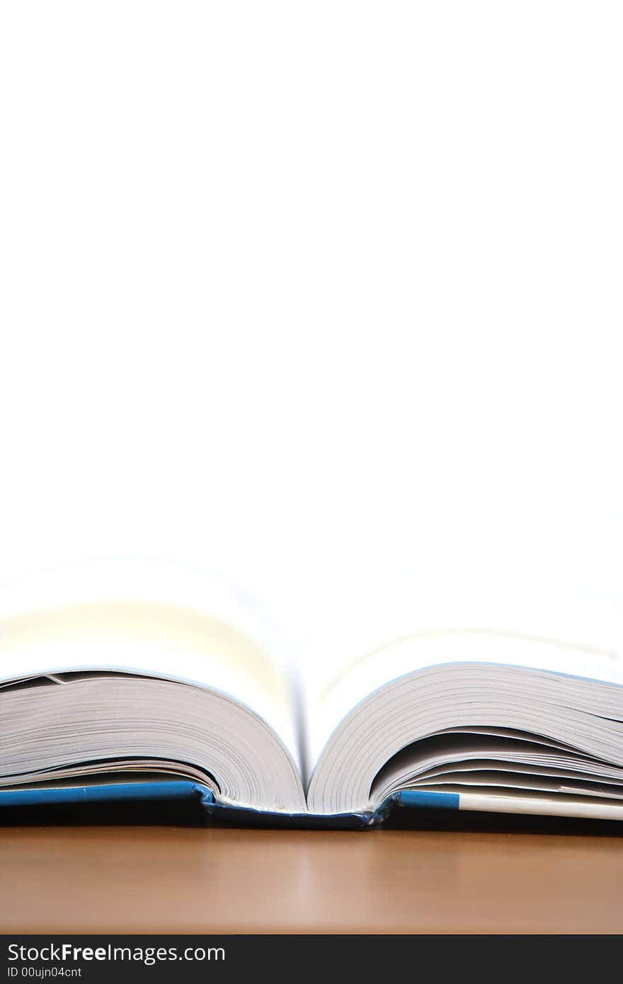 An open book on a desk in a class room