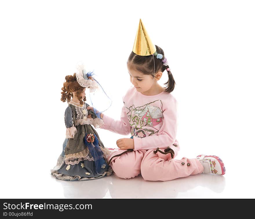 The little girl with a doll isolated on a white background