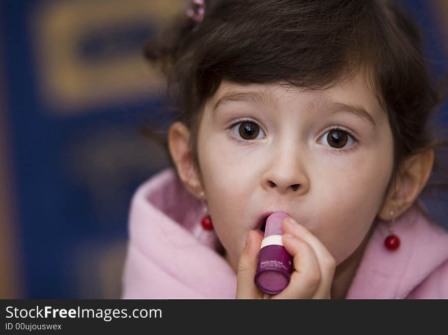 Young girl with lipstick in the pink  sweatshirt