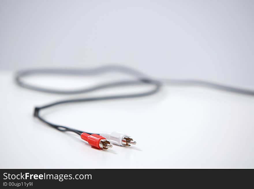 An audio cable in the studio on white background