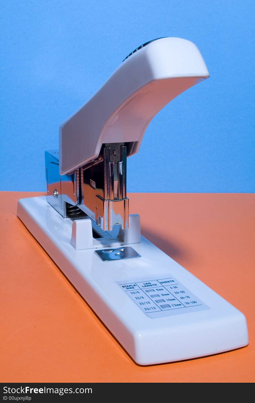 Large stapler on the coloured background