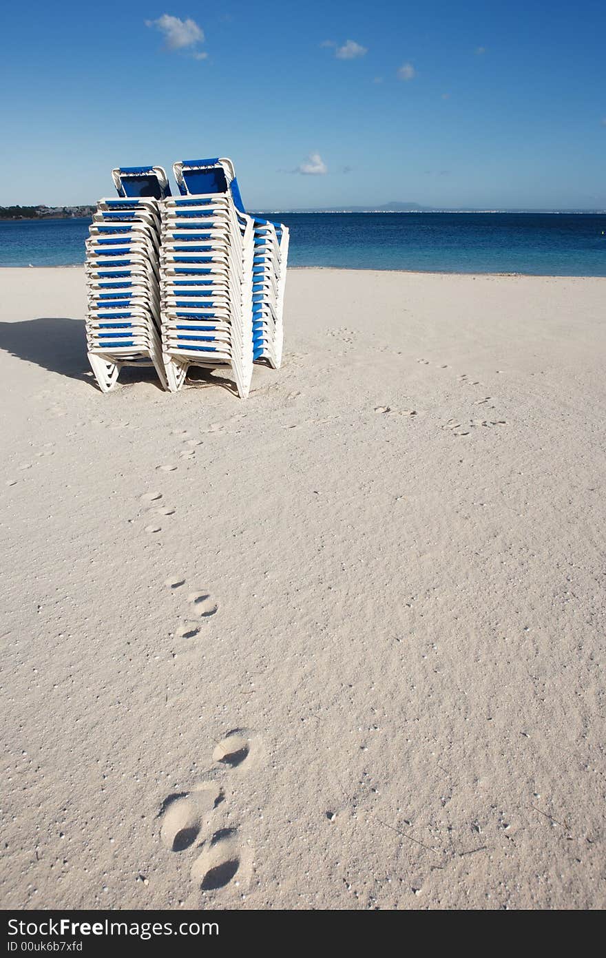 Staple of lounge chairs at beach