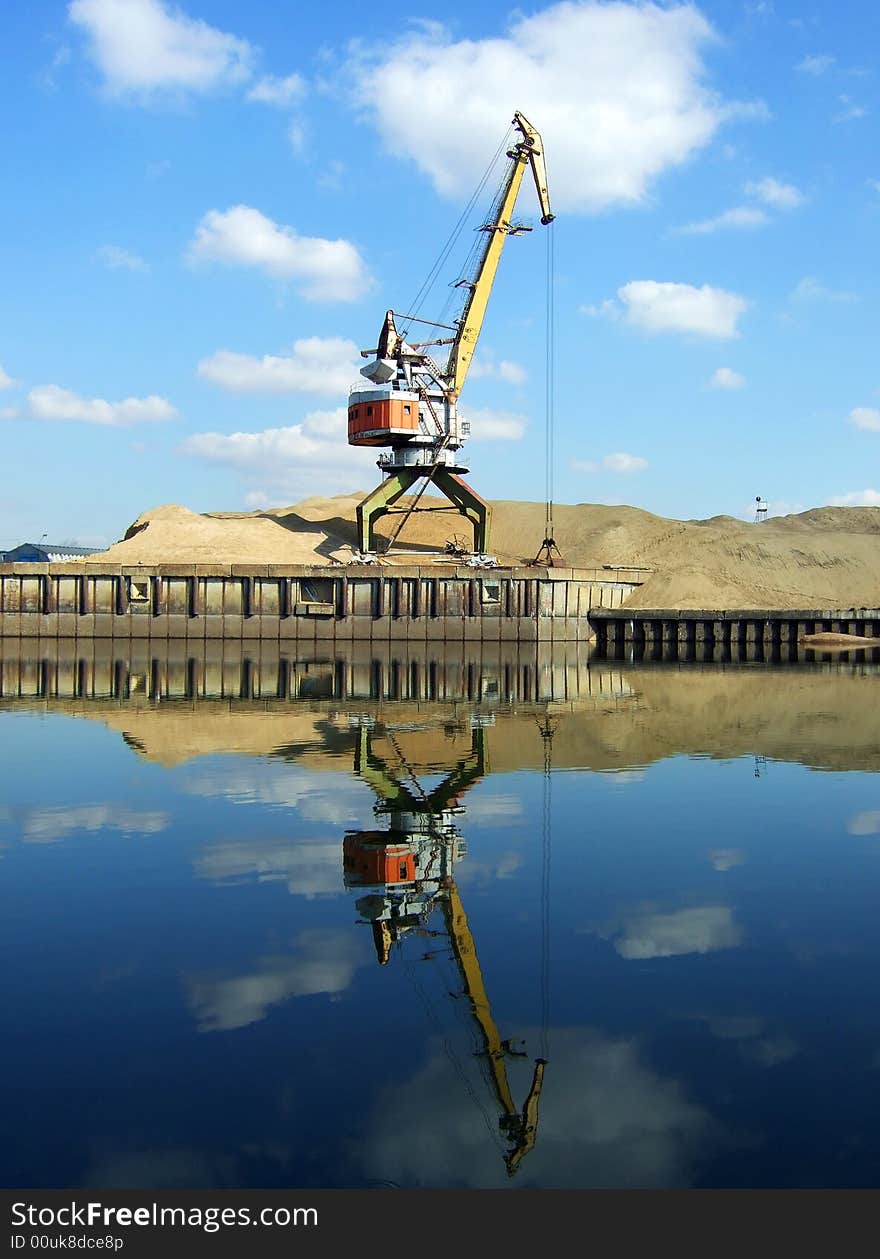 Crane with bucket and reflection in water. Crane with bucket and reflection in water