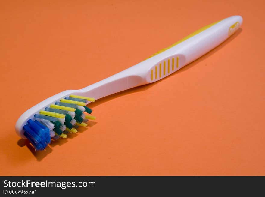 Tooth brush on an orange background