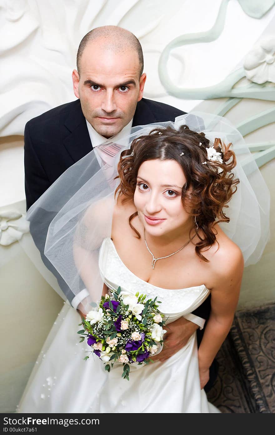 Just married young couple in wedding wear with bridal bouquet. Special toned photo f/x