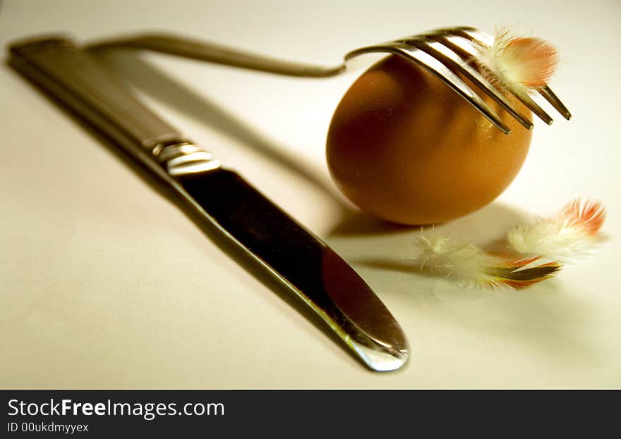 One egg with a fork and knife and fuzz