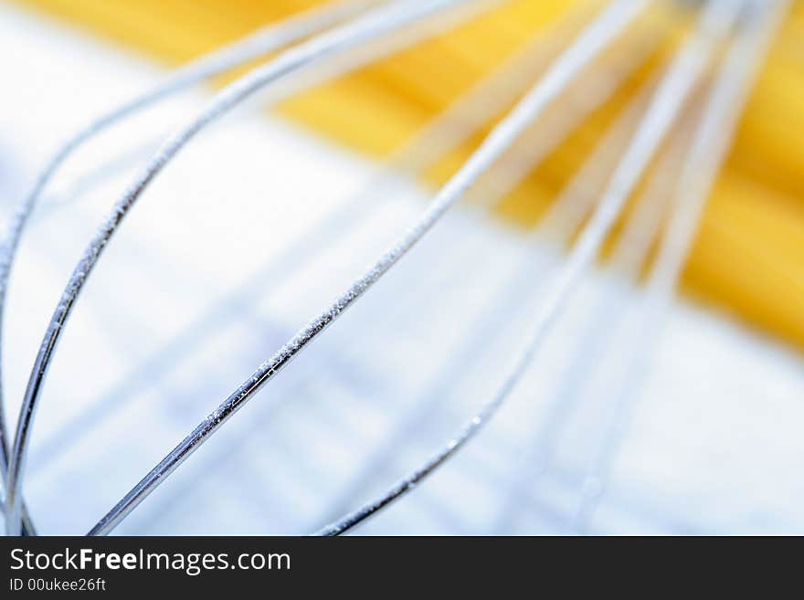 Wire Whisk And Spaghetti On Flour