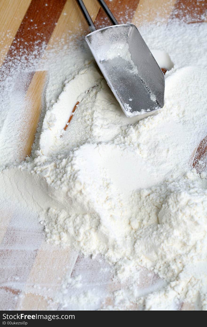 Metal scoop and flour, background