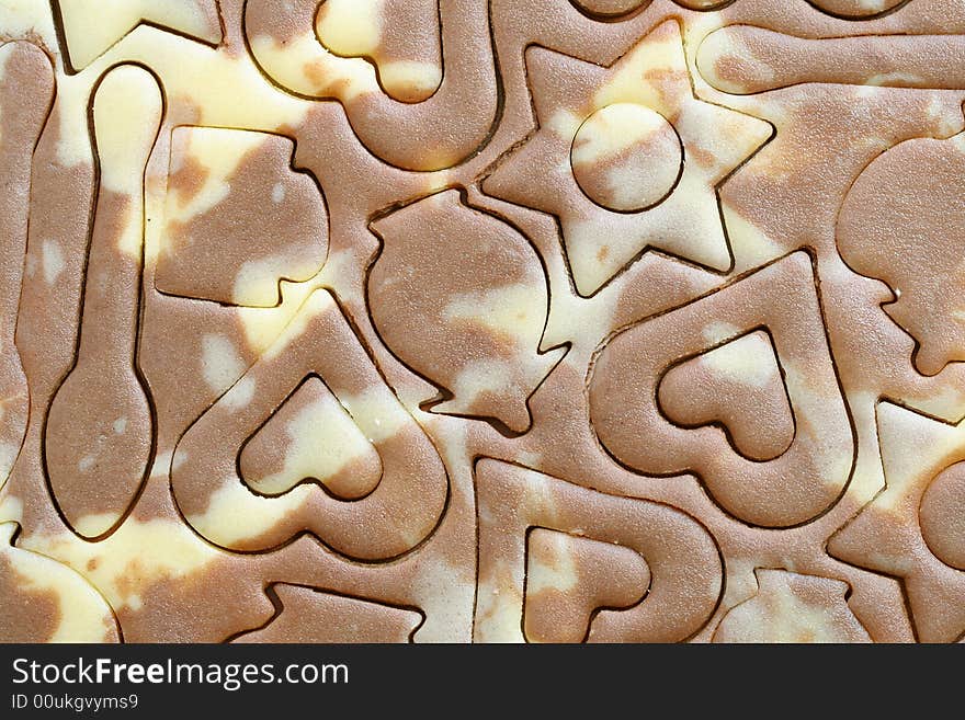 Various figures on a chocolate dough