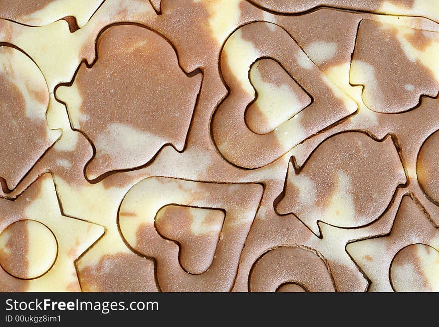 Various figures on a chocolate dough