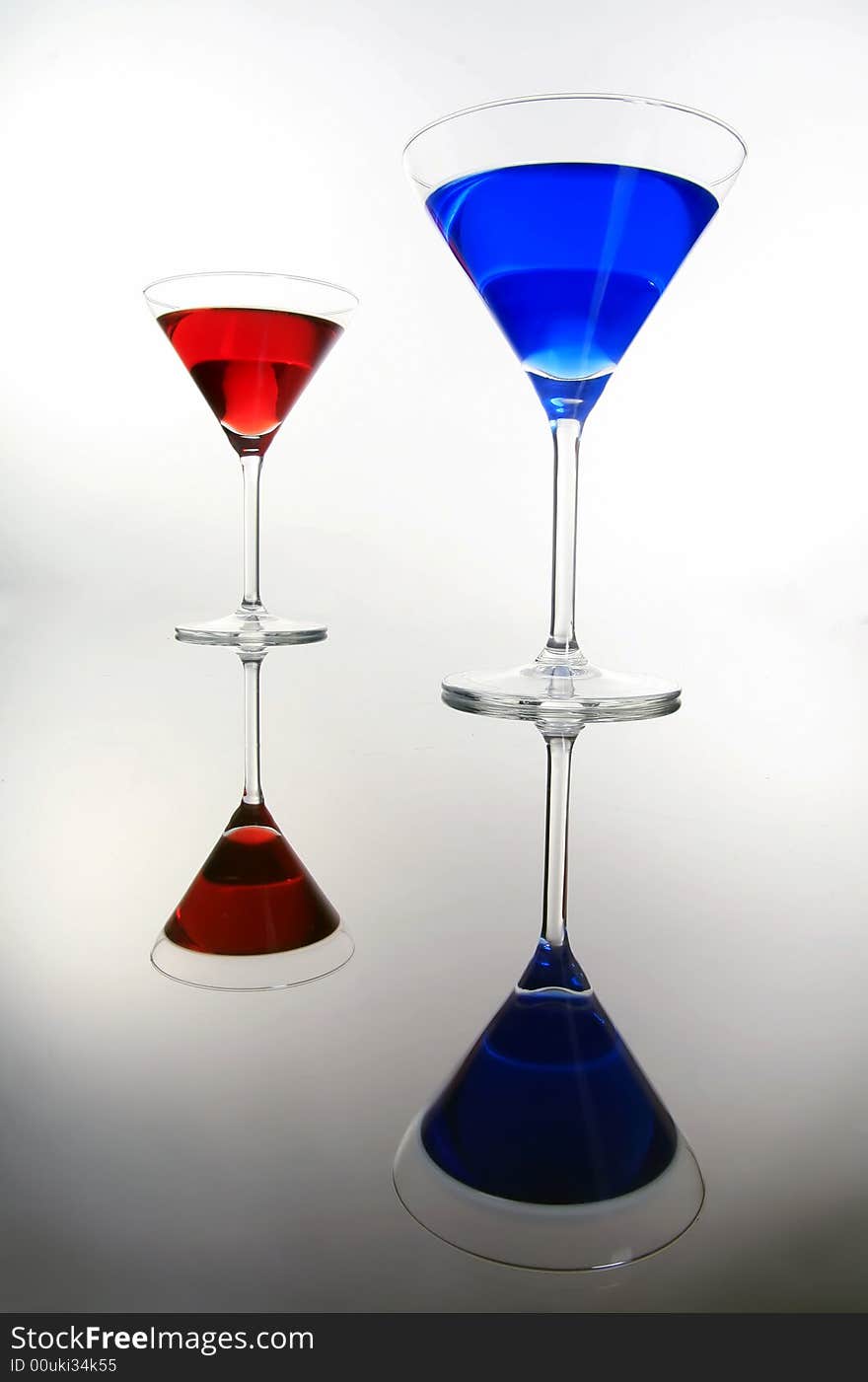 Red and blue coctail are standing on the table. Red and blue coctail are standing on the table