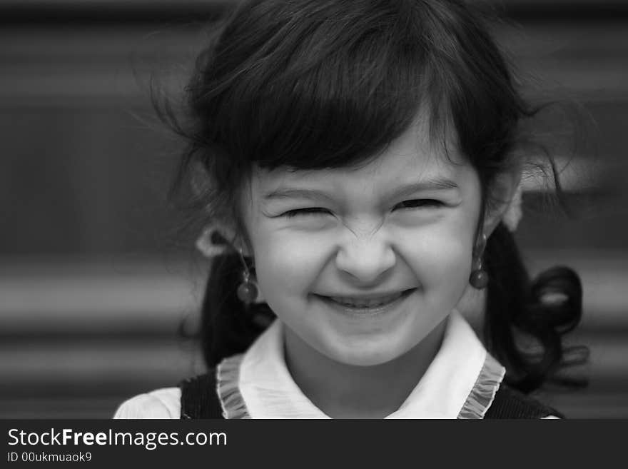 Smiling girl with ponytails on the black-white photo