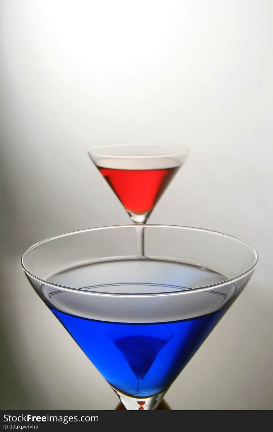 Macro shot of a blue coctail with red behind. Macro shot of a blue coctail with red behind