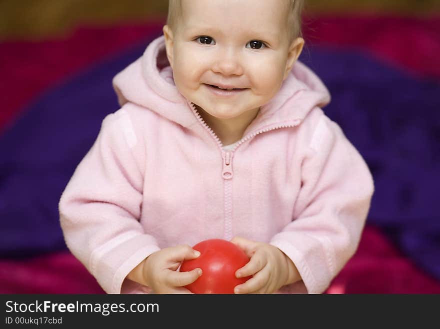 Girl with small ball on violet background