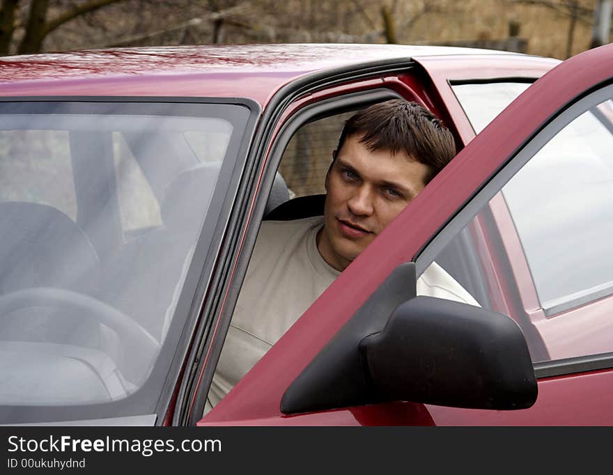 Young person with red car. Young person with red car