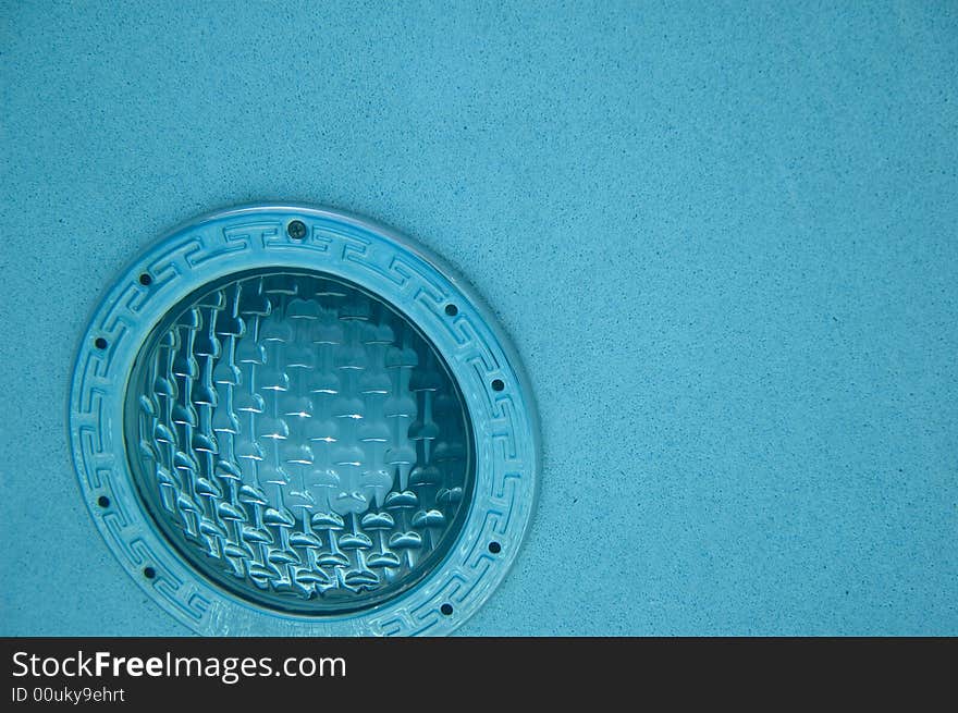 Underwater swimming pool light in blue colored water