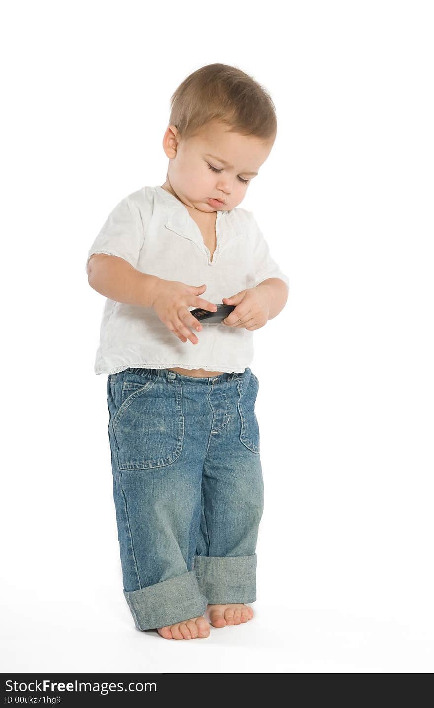 A little boy experimenting with a cellphone. A little boy experimenting with a cellphone