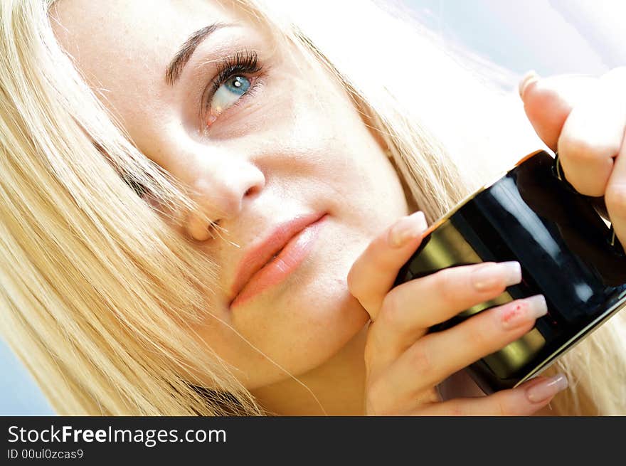 The portrait of a young woman with a mug of coffee. The portrait of a young woman with a mug of coffee.