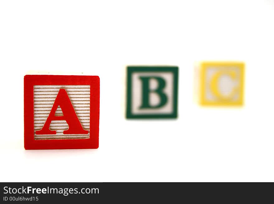 Three wood alphabet blocks with the letters a b and c. Three wood alphabet blocks with the letters a b and c