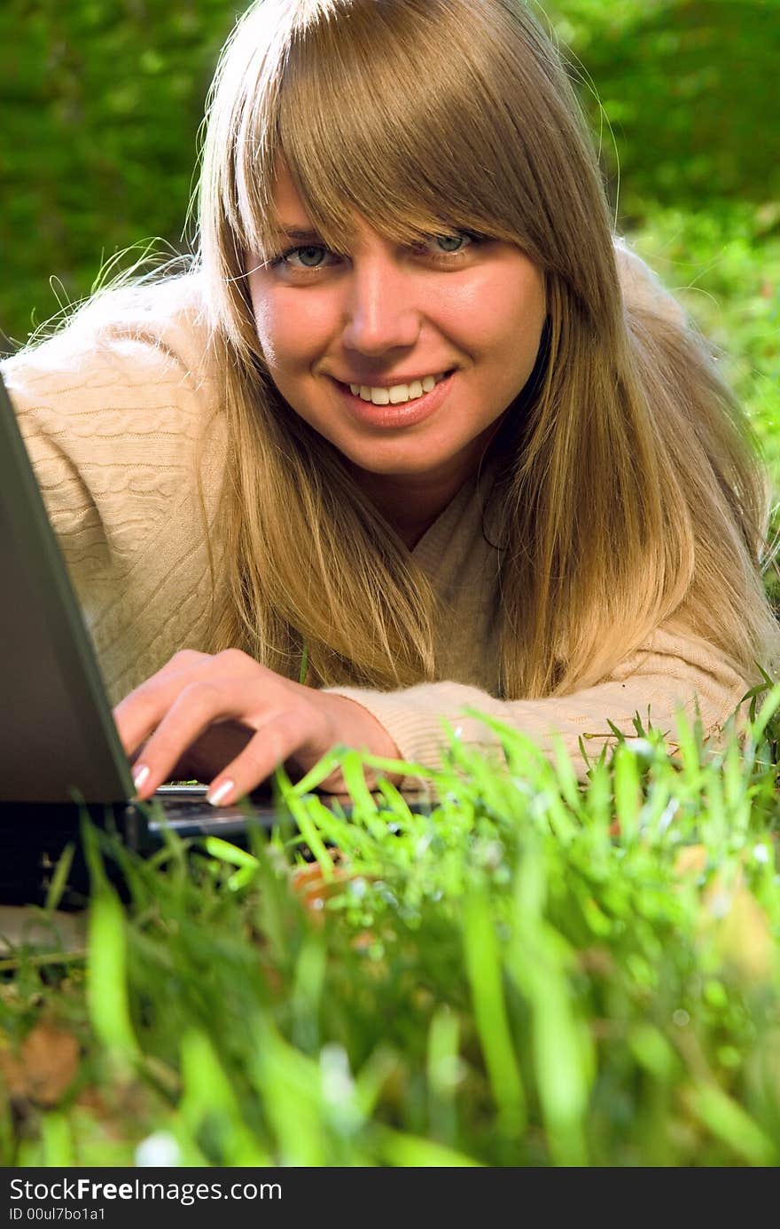 Beautiful young girl with laptop outdoor portrait