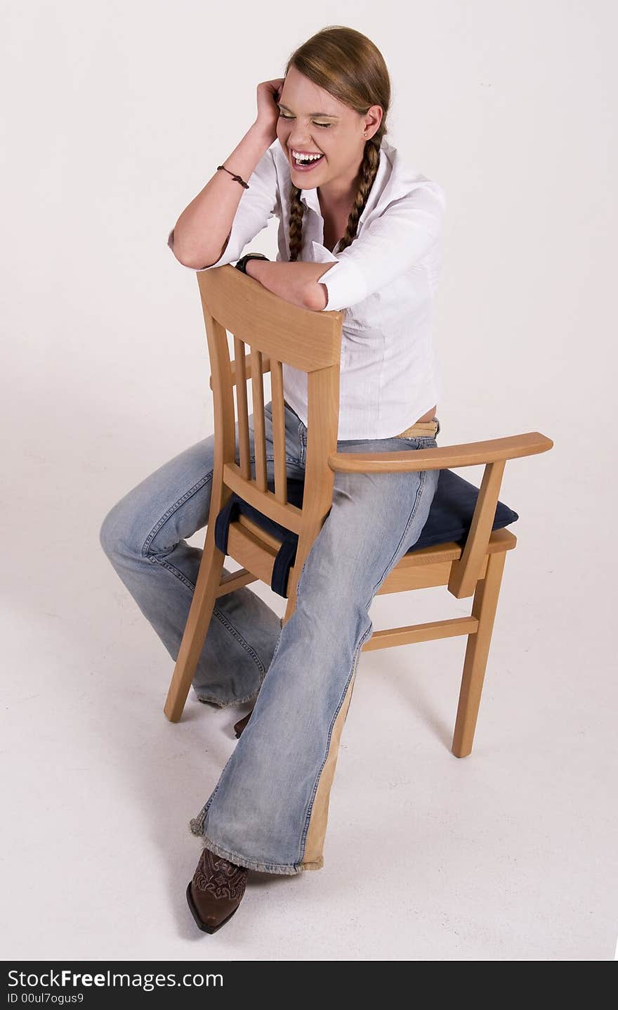 Laughing girl sitting on a chair. Laughing girl sitting on a chair