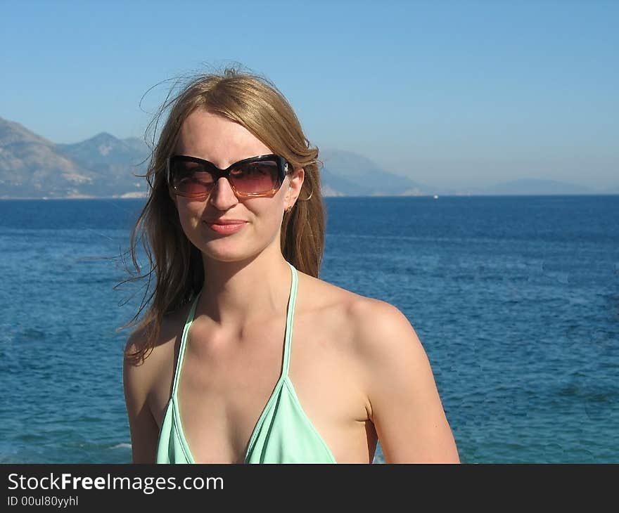 The beautiful girl is sunbathing on the beach. The beautiful girl is sunbathing on the beach