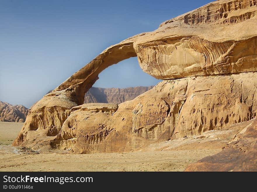 Stone arch on blue sky background