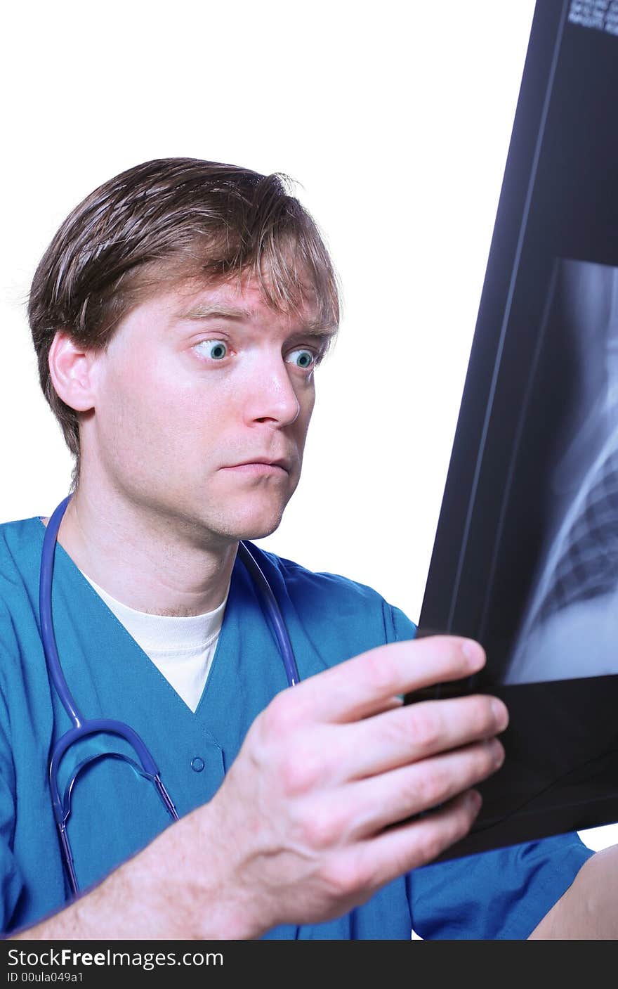 Male doctor looking with humorous shock at x ray. Male doctor looking with humorous shock at x ray