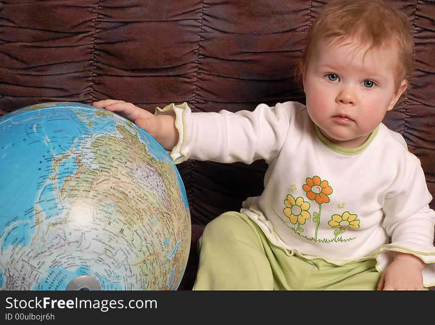 Portrait of the little girl on a brown background