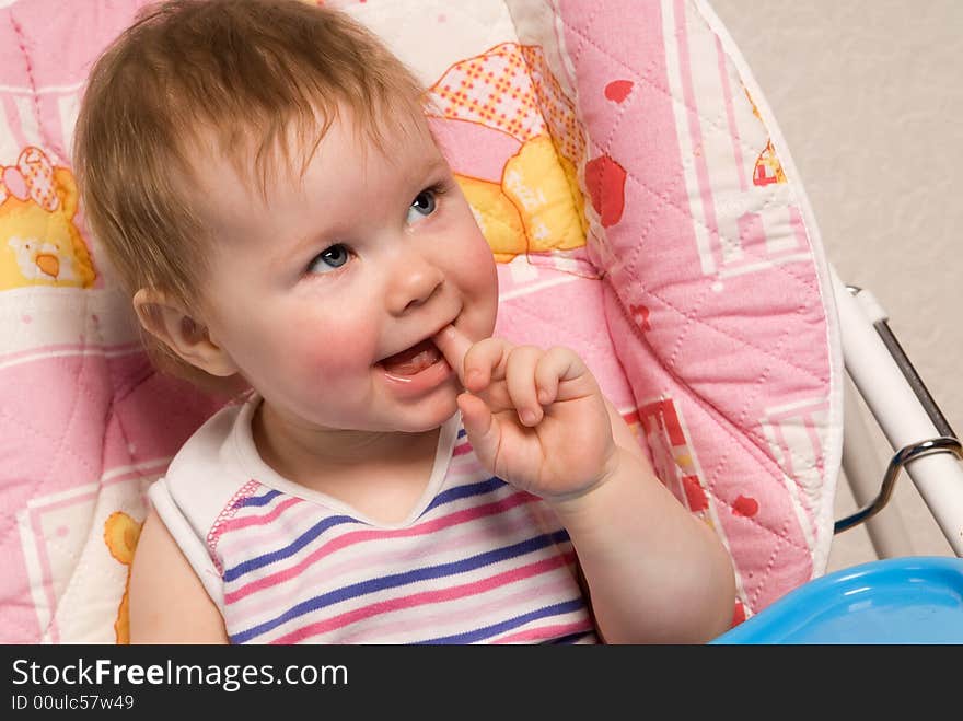 Portrait of the beautiful little girl behind a table. Portrait of the beautiful little girl behind a table