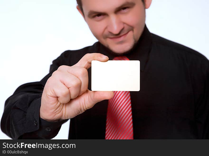 Well-dressed businessman holding an empty business card. Well-dressed businessman holding an empty business card