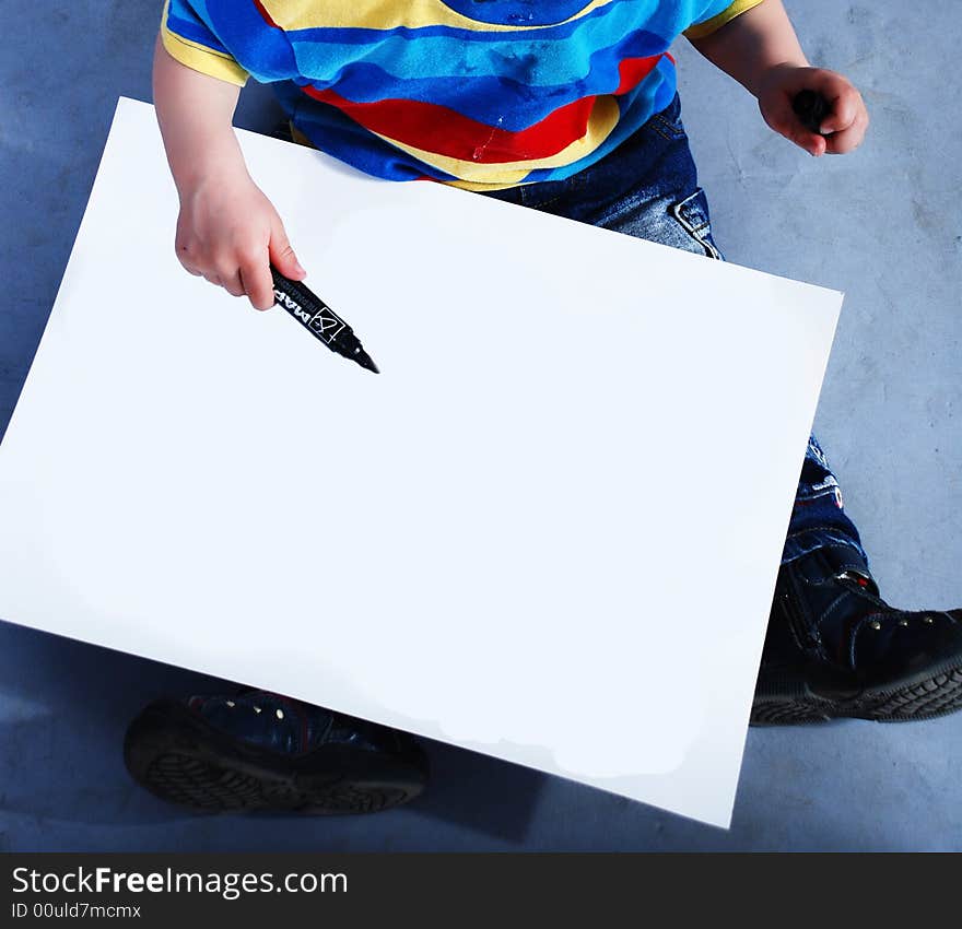 Child with white paper at blue background