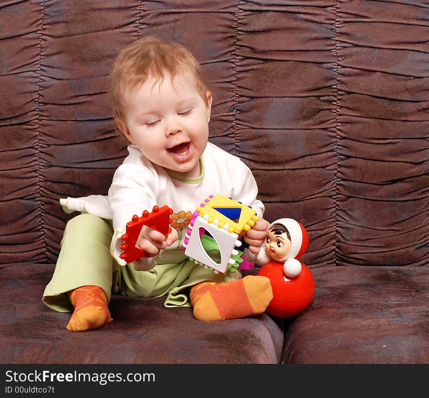 Portrait of the little girl on a brown background