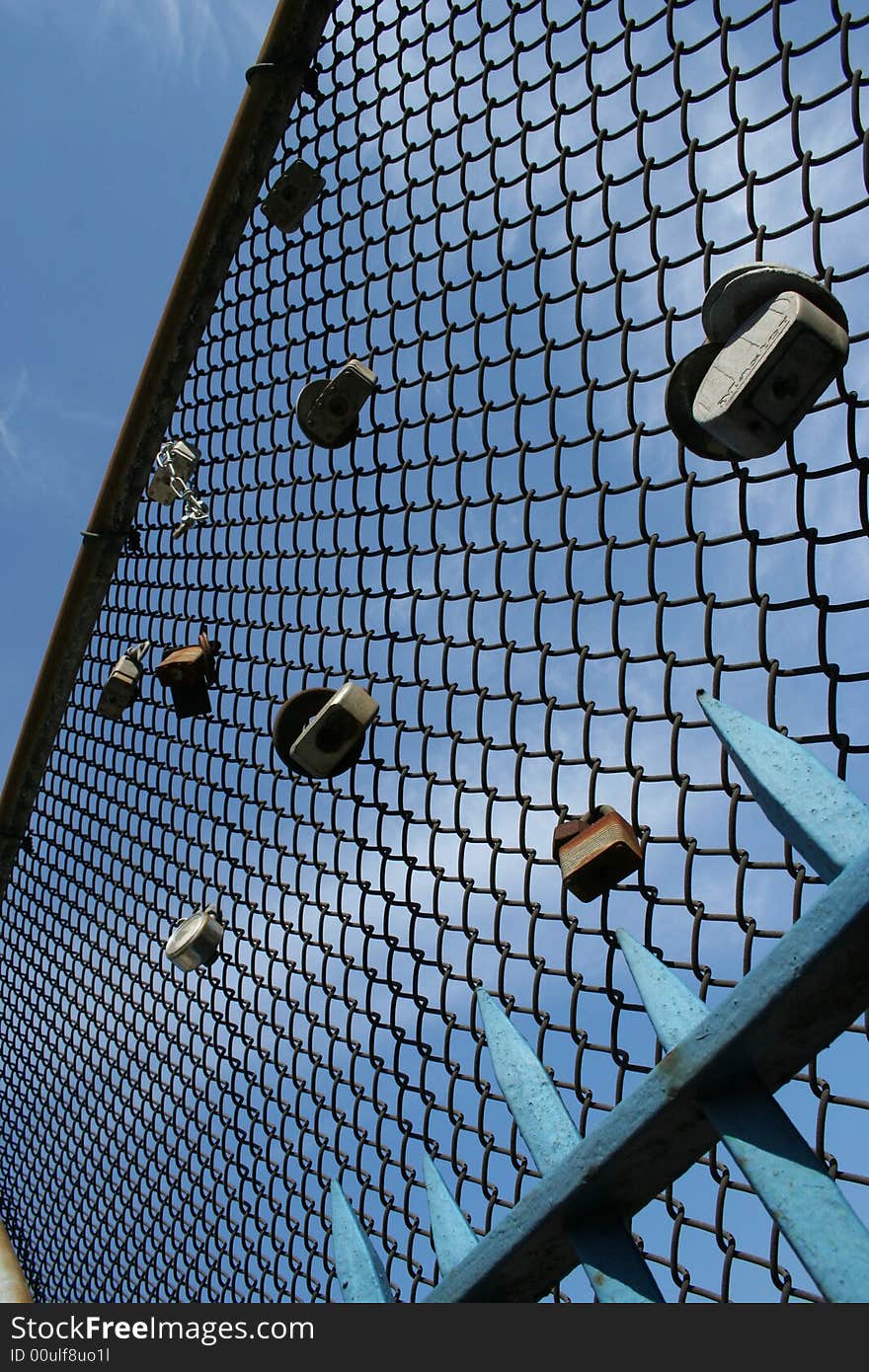 Padlocks on a wire mesh, sign of  love that binds two teenagers