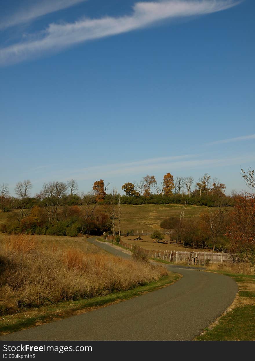 Winding country road with blue sky and fall foliage