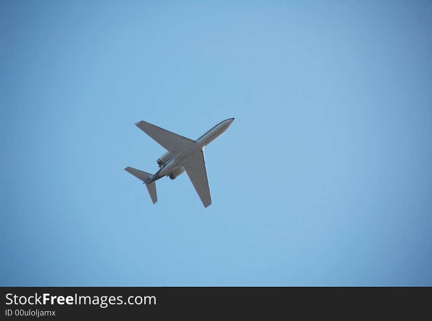 An aeroplane in the blue sky. An aeroplane in the blue sky