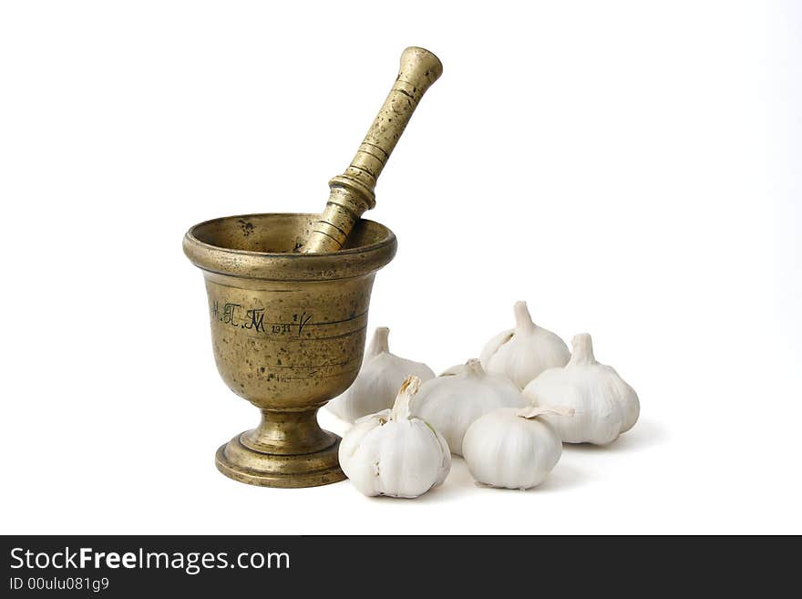 Bronze mortar with bulbs of garlic, isolated on white background. Bronze mortar with bulbs of garlic, isolated on white background