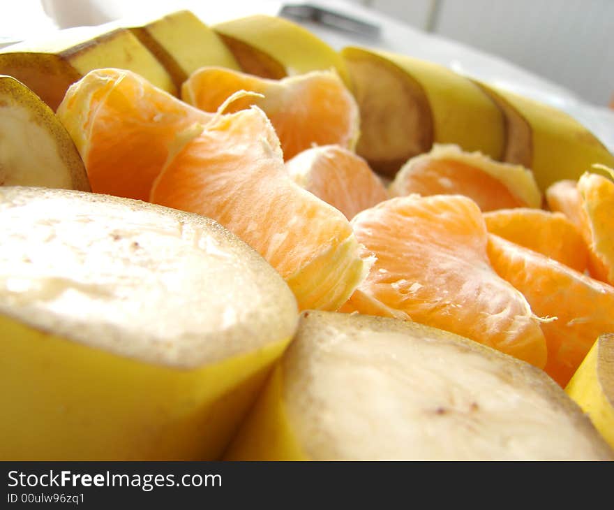 Different kind of fresh fruits bananas and mandarines