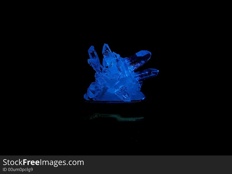 Gift a Blue crystal of a mineral, on a black background