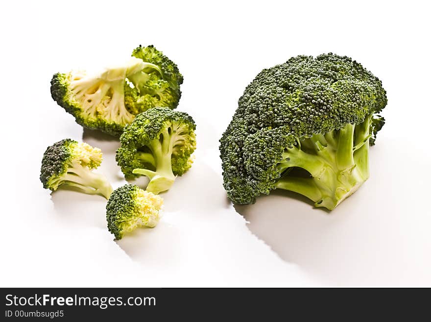 Macro picture, two heads of broccoli over white