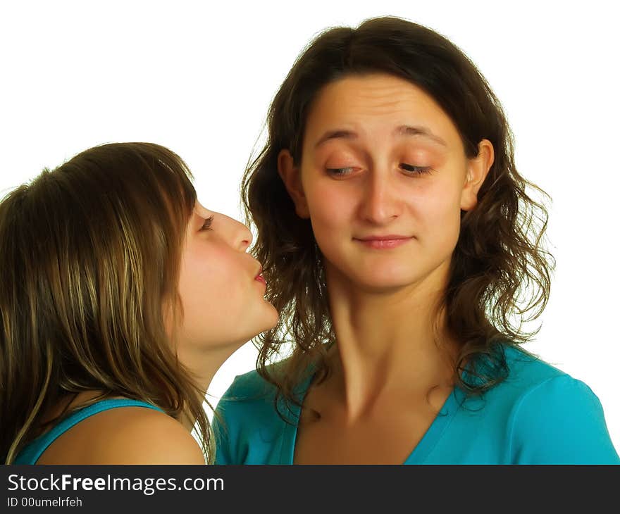 A blond pretty lady wants to kiss the other girl with brown hair. A blond pretty lady wants to kiss the other girl with brown hair