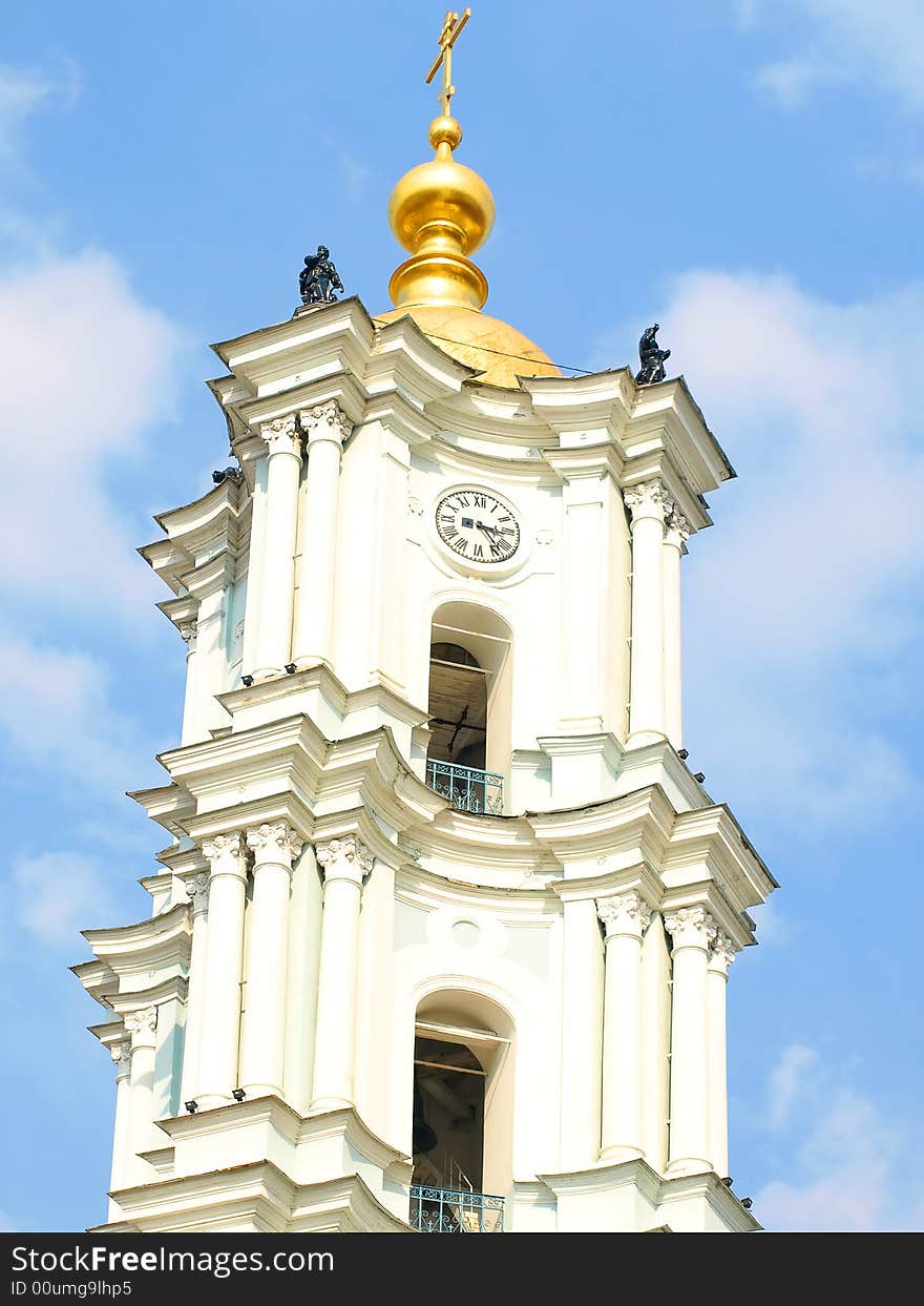 Tall white church tower with the golden dome