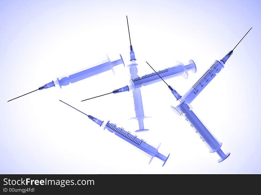 Plastic disposable syringes, toned in blue color.