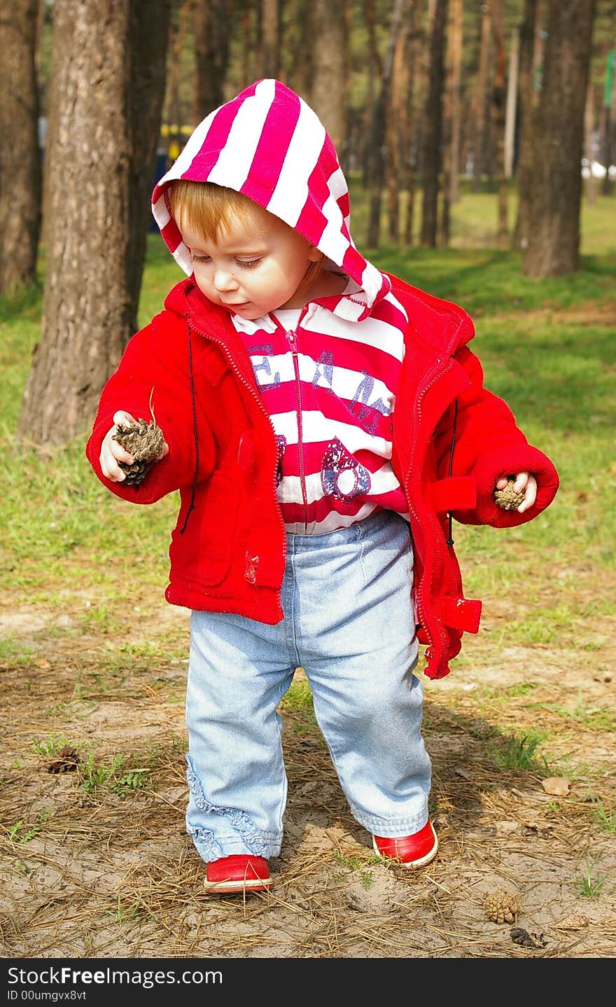 Little girl walks  in a wood