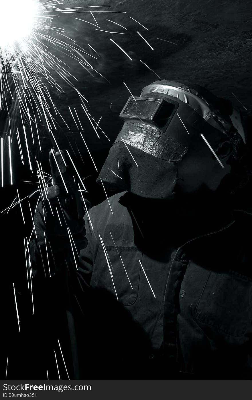 A welder working at shipyard at night. A welder working at shipyard at night