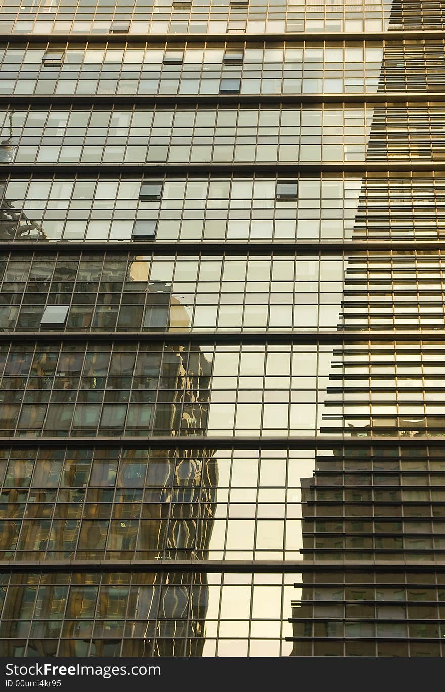 Reflections of two office buildings in a modern building
in Beijing. Reflections of two office buildings in a modern building
in Beijing.