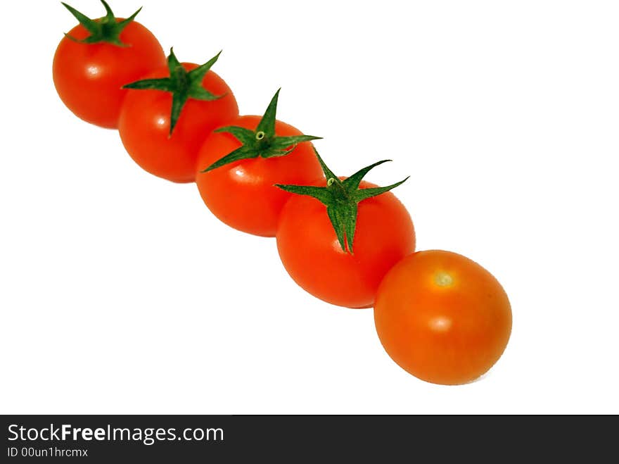 Five cherry tomatoes on a white background. Food ingredients