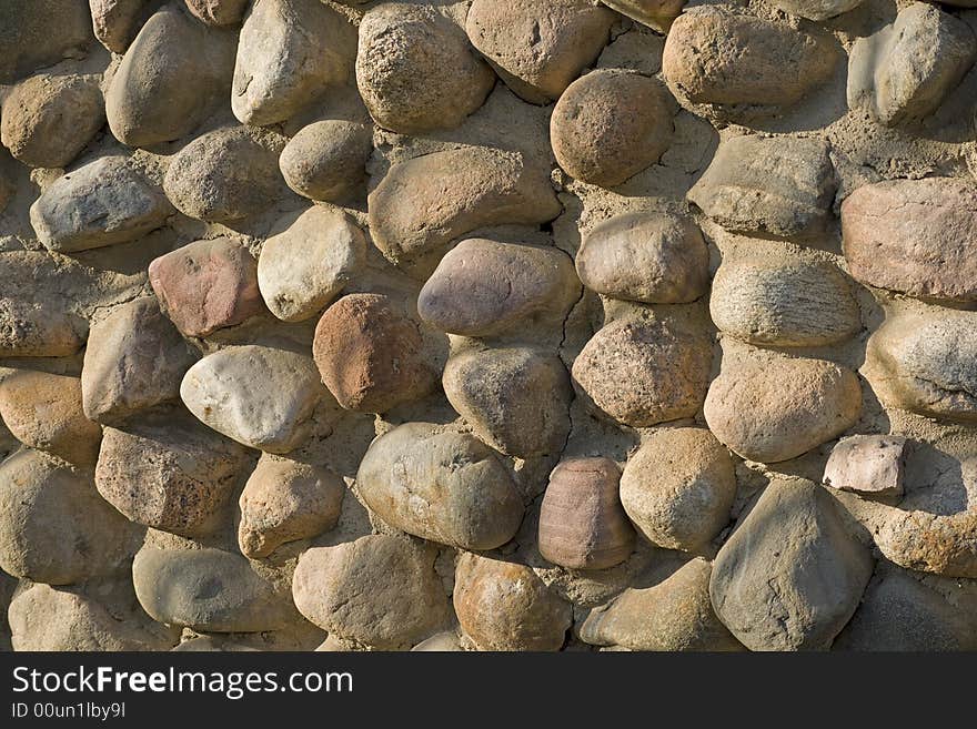 Stone wall made of round granite cobblestones