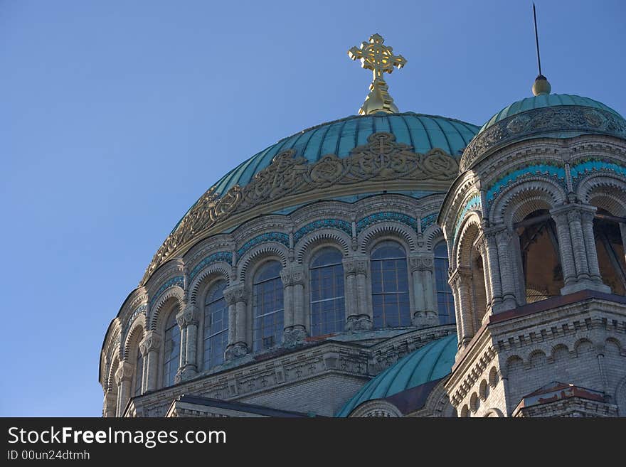 Cupolas of church with the cross against the background of the sky