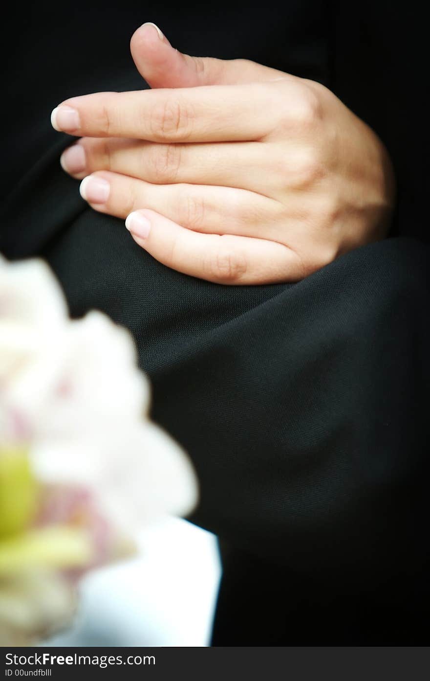 An image of a brides hand around her fathers arm before walking down the isle